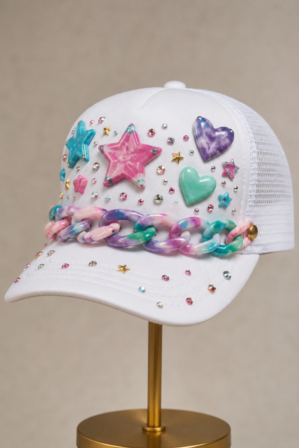 White cap with acrylic chain and star embellishments